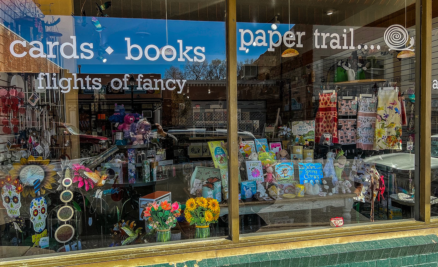 The store front window of Paper Trail gift store in Las Vegas, New Mexico.